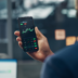 Man_holding_a_phone_showing_a_stock_market_chart.png